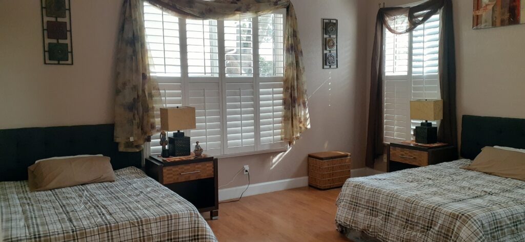 A restful private bedroom with bedside lamps and comfortable furnishings.